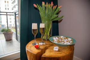 a table with two glasses of champagne and a bowl of food at Maya's Flats & Resorts 62 - 3 rooms apartment BASTION WALOWA Gdańsk in Gdańsk