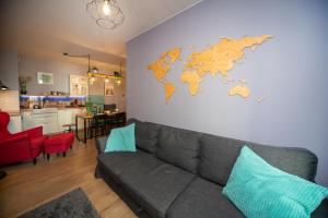 a living room with a couch and a map on the wall at Maya's Flats & Resorts 62 - 3 rooms apartment BASTION WALOWA Gdańsk in Gdańsk