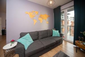 a living room with a couch and a world map on the wall at Maya's Flats & Resorts 62 - 3 rooms apartment BASTION WALOWA Gdańsk in Gdańsk