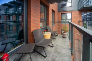 a balcony with chairs and a table on a building at Maya's Flats & Resorts 62 - 3 rooms apartment BASTION WALOWA Gdańsk in Gdańsk