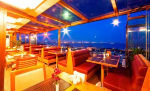 a restaurant with tables and chairs and a view of the city at Azade Suites in Istanbul