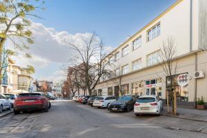 a street with cars parked on the side of the road at Skandynawski - 4 osobowy apartament przy Monte Cassino by Grand Apartments in Sopot