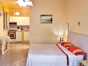 a bedroom with a bed and a kitchen at Tiziana in Giardini Naxos