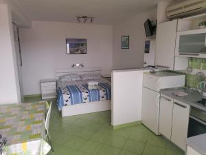 a small kitchen with a bed in a room at Apartments Marija in Jelsa