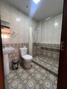 a bathroom with a toilet and a shower and a sink at 2nd floor in Bukhara