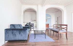 a living room with a blue couch and a table at Casa Andrea in Menaggio