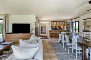 a living room with a couch and a table at Luxury Golf Villa Torremirona in Navata
