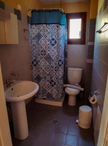 a bathroom with a sink and a toilet and a shower at Stella Apartments in Marathokampos