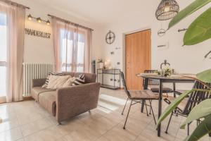 a living room with a couch and a table at Varenna Wanderlust in Perledo +26 photos