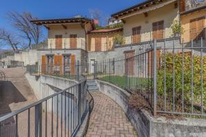 a wrought iron fence in front of a house at Varenna Wanderlust in Perledo