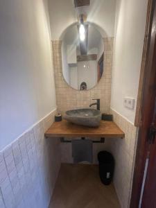 a bathroom with a sink and a mirror at Acogedora casa con patio-parking in Albarracín