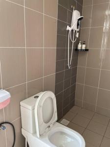 a bathroom with a toilet with the seat up at Homestay Balik Pulau 2.0 3BedRoom in Balik Pulau