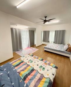 a living room with a bed and a comforter on the floor at Homestay Balik Pulau 2.0 3BedRoom in Balik Pulau
