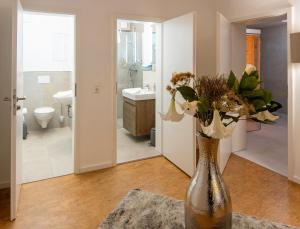 a vase filled with flowers on a table in a bathroom at Romantik Hotel Landhaus Biewald in Göttingen +72 photos