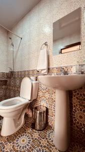 a bathroom with a toilet and a sink at 2nd floor in Bukhara