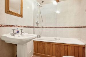 a bathroom with a sink and a shower at The Coppermines Mountain Cottages Sawyers, Carpenters, Millrace, Pelton Wheel, Sleeps 22 in Coniston