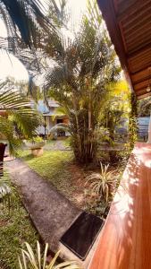 uma vista para um jardim com palmeiras e uma casa em Lal Home Stay em Sigiriya