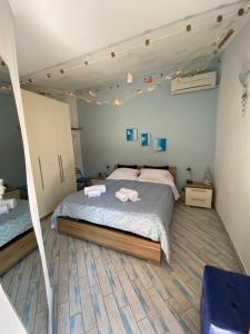 a bedroom with a bed with two towels on it at Dolce Estate Cefalù in Cefalù