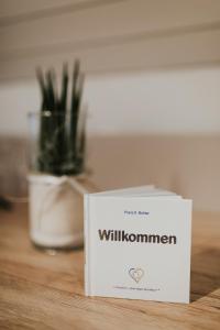 a white box sitting on a table next to a plant at Gartenhaus by Ochsen Lenzburg in Lenzburg