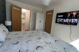 Llit o llits en una habitació de Cheerful 4-bedroom house with multiple car parking