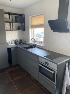 a kitchen with a sink and a counter top at Appartement Juf in Lisse