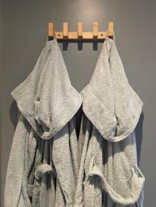 a towel is hanging on a clothes rack at Déliv'Love in Douvres-la-Délivrande