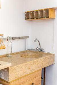a kitchen sink with a wooden counter top at Petit Nid par Dodo-à-Cassis in Cassis