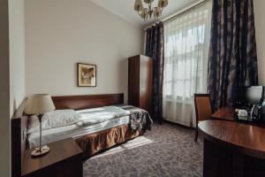 Posteľ alebo postele v izbe v ubytovaní Hotel Rezydent