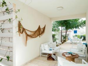 a living room with white furniture and a patio at Lisca Bianca in San Vito lo Capo