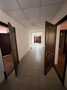 an empty hallway with two doors and a tile floor at База відпочинку «Павлоградець» in Orlovshchina