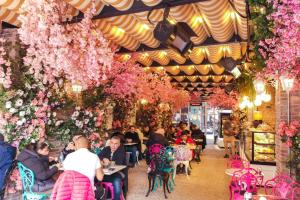 a group of people sitting at tables in a room filled with flowers at Ring Stone Hotels Bosphorus - Special Class in Istanbul