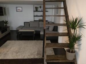 a living room with a ladder and a couch at Central King Apartment in Budapest