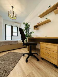 a bedroom with a desk and a chair at Luxury Studios in Iaşi