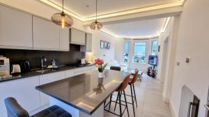 a kitchen with a large island in a room at Surbiton Luxury Garden House 19 in Surbiton