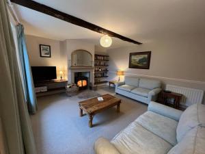 a living room with a couch and a table at Stunning 4-bed Grade II house in the Lake District in Wigton