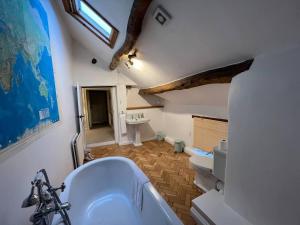 a bathroom with a white tub and a sink at Stunning 4-bed Grade II house in the Lake District in Wigton