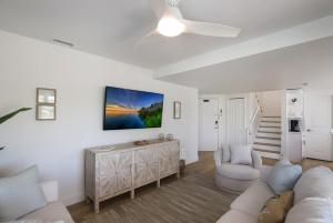 a living room with a couch and a table at Hidden Pearl home in Holmes Beach +18 photos