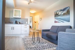 a living room with a couch and a table at Apex Nürburg in Nürburg