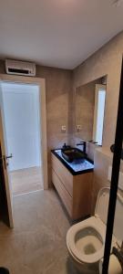 a bathroom with a toilet and a sink at Apartman Gaby in Podstrana +22 photos