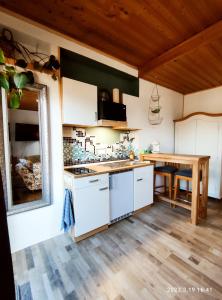 a kitchen with white cabinets and a wooden table at Ferienwohnung Beeden - zur Glasschmiede in Homburg