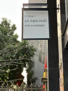 a sign hanging on the side of a building at Hà Thịnh Phát Apartment in Hai Phong