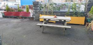 stół piknikowy i ławka w ogrodzie w obiekcie Self Catering Cellb Ffestiniog w mieście Blaenau-Ffestiniog