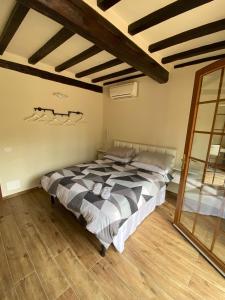 a bedroom with a large bed in a room with wooden floors at Corte Ca' Bosco in Castello di Serravalle