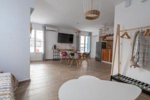 eine Küche und ein Wohnzimmer mit einem Tisch und Stühlen in der Unterkunft Luxury Apartment En Lefko in Poros