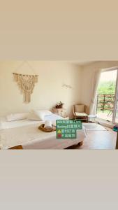 a bedroom with a bed and a large window at W24墾丁民宿墾丁大街一館bnb in Kenting