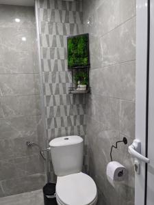 a small bathroom with a toilet and a window at Welcome Stara Zagora Apartment 4 Guests Pet Friendly in Stara Zagora