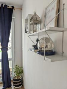 a living room with shelves and a window at Chill Breeze Apartment in Stara Zagora +19 photos