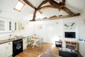 a living room with a kitchen and a dining room at OLD CHAPEL Hayton Cumbria CA89HR in Hayton