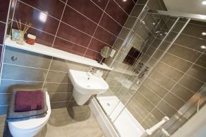 a bathroom with a toilet and a sink and a shower at OLD CHAPEL Hayton Cumbria CA89HR in Hayton +51 photos