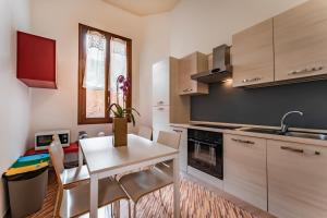 a kitchen with a small white table and chairs at Residenza Manin Apartments in Venice